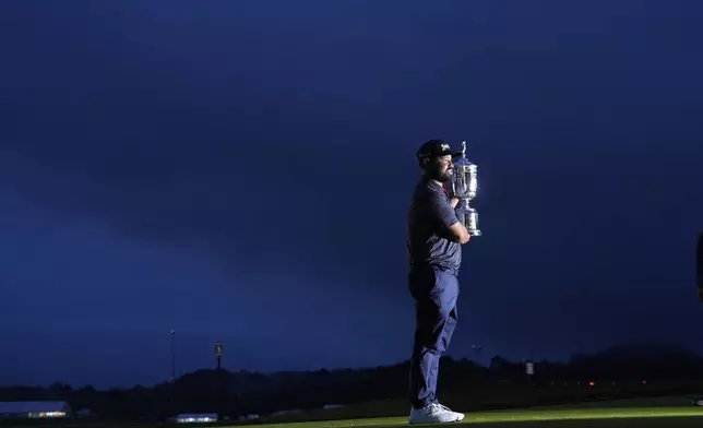 J.J. Spaun celebrates with the trophy after winning the U.S. Open golf tournament at Oakmont Country Club Sunday, June 15, 2025, in Oakmont, Pa. (AP Photo/Charlie Riedel)