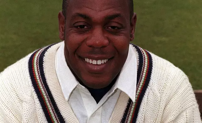 PA FILE - David 'Syd' Lawrence of Gloucestershire County Cricket Team, the first British-born black cricketer to play for England, smiles on June 2, 1998, Lawrence has died at the age of 61. (PA via AP)