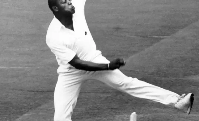 PA FILE - David 'Syd' Lawrence, the first British-born black cricketer to play for England, attends a game on Aug. 25, 1988, Lawrence has died at the age of 61. (PA via AP)