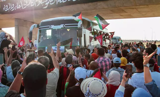 People cheer as a convoy of buses made up of activists, lawyers and medical professionals from North Africa depart from Tunisia to Gaza to break Israel's blockade on the territory, in Gabes, Tunisia, Monday, June 9, 2025. (AP Photo)
