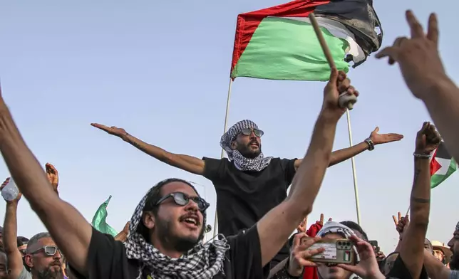 People cheer as a convoy of buses made up of activists, lawyers and medical professionals from North Africa depart from Tunisia to Gaza to break Israel's blockade on the territory, in Gabes, Tunisia, Monday, June 9, 2025. (AP Photo)