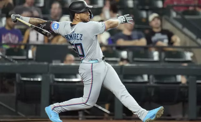 Miami Marlins' Agustín Ramírez connects for a triple against the Arizona Diamondbacks during the first inning of a baseball game Sunday, June 29, 2025, in Phoenix. (AP Photo/Ross D. Franklin)