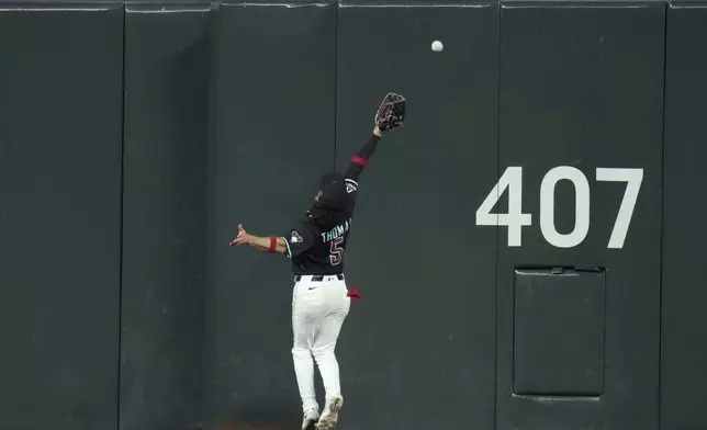Arizona Diamondbacks center fielder Alek Thomas is unable to make a play on a triple hit by Miami Marlins' Agustín Ramírez during the first inning of a baseball game Sunday, June 29, 2025, in Phoenix. (AP Photo/Ross D. Franklin)