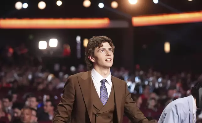Jack Nesbitt walks to the stage after being drafted by the Philadelphia Flyers during the NHL hockey draft Friday, June 27, 2025, in Los Angeles. (AP Photo/Damian Dovarganes)