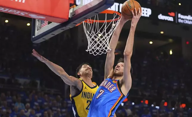 Oklahoma City Thunder forward Chet Holmgren (7) dunks against Indiana Pacers guard Ben Sheppard (26) during the first half of Game 2 of the NBA Finals basketball series Sunday, June 8, 2025, in Oklahoma City. (AP Photo/Julio Cortez)