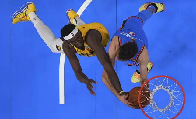 Indiana Pacers forward Pascal Siakam (43) reaches for the ball against Oklahoma City Thunder forward Chet Holmgren (7) during the first half of Game 2 of the NBA Finals basketball series Sunday, June 8, 2025, in Oklahoma City. (Kyle Terada/Pool Photo via AP)