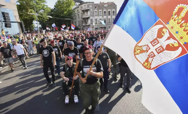 Serbian military veterans march along with students march during of a major anti-government rally pressing for an early election after nearly eight months of almost daily anti-corruption demonstrations that have shaken the populist government of President Aleksandar Vucic, in Belgrade, Serbia, Saturday, June 28, 2025. (AP Photo/Darko Vojinovic)