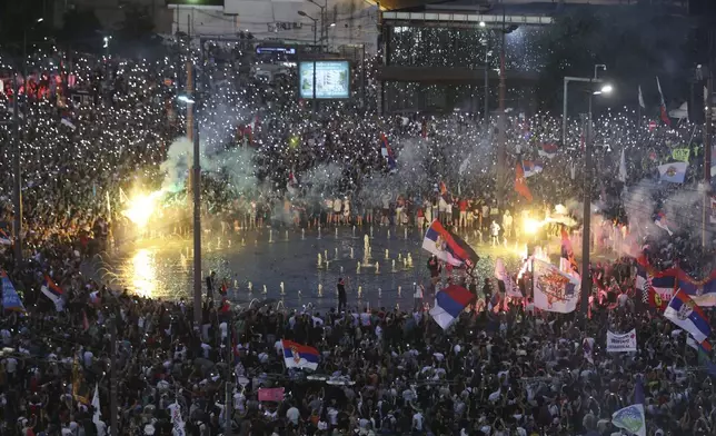 People wave their mobile phones with flashing lights during a major anti-government rally in Belgrade, Serbia, Saturday, June 28, 2025. (AP Photo/Marko Drobnjakovic)