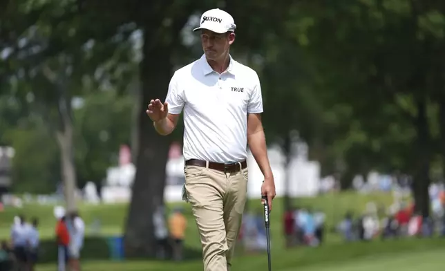 Andrew Putnam waves after his birdie putt on the eighth hole during the first round of the Rocket Classic golf tournament at the Detroit Golf Club, Thursday, June 26, 2025, in Detroit. (AP Photo/Paul Sancya)