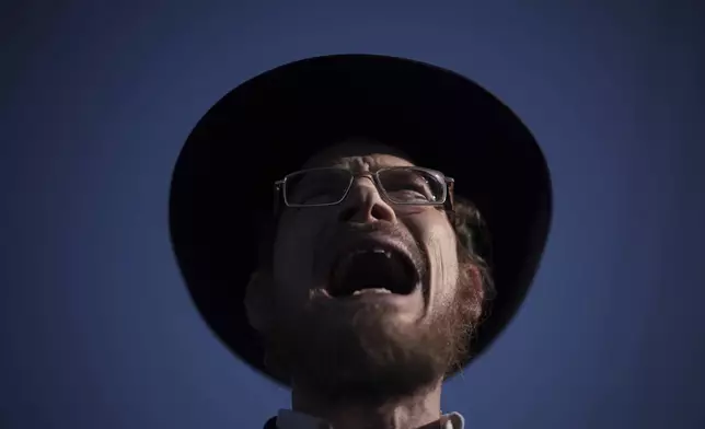 An ultra-Orthodox Jewish man shouts during a protest against army recruitment in Bnei Brak, Israel, Thursday, June 5, 2025. (AP Photo/Leo Correa)