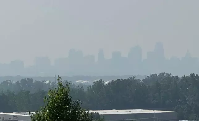 Smoke from Canadian wildfires can be seen partially obscuring the skyline of downtown Kansas City, Missouri on Wednesday, June 4, 2025. (AP Photo/Nick Ingram)