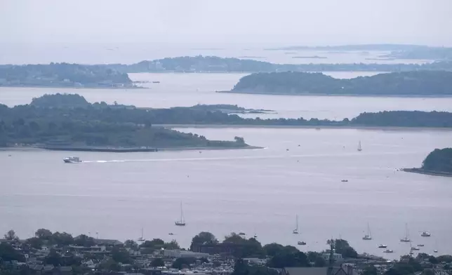 Hazy skies diminish the view of the Boston Harbor Islands, Wednesday, June 4, 2025, in Boston, Mass. (AP Photo/Robert F. Bukaty)