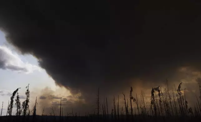 FILE - Wildfire smoke hangs in the air above Highway 97 north of Buckinghorse River, British Columbia, May 30, 2025. (Nasuna Stuart-Ulin/The Canadian Press via AP, File)