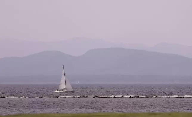 Hazy skies due to smoke from wildfires in Canada are seen over Lake Champlain and the Adirondack Mountains on Wednesday, June 4, 2025, in Burlington, Vt. (AP Photo/Amanda Swinhart)