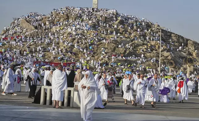 Muslim pilgrims gather on top of the rocky hill known as the Mountain of Mercy, on the Plain of Arafat, during the annual Hajj pilgrimage near the holy city of Mecca, Saudi Arabia, Thursday, June 5, 2025. (AP Photo/Amr Nabil)