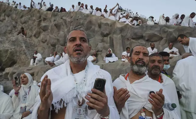 Muslim pilgrims offer prayers at top of the rocky hill known as the Mountain of Mercy, on the Plain of Arafat, during the annual Hajj pilgrimage near the holy city of Mecca, Saudi Arabia, Thursday, June 5, 2025. (AP Photo/Amr Nabil)