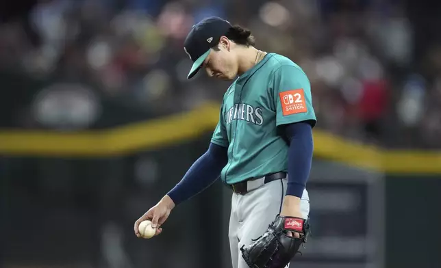 Seattle Mariners starting pitcher Bryan Woo pauses on the pitcher's mound after giving up a walk to Arizona Diamondbacks' Josh Naylor to load the bases during the sixth inning of a baseball game Wednesday, June 11, 2025, in Phoenix. (AP Photo/Ross D. Franklin)