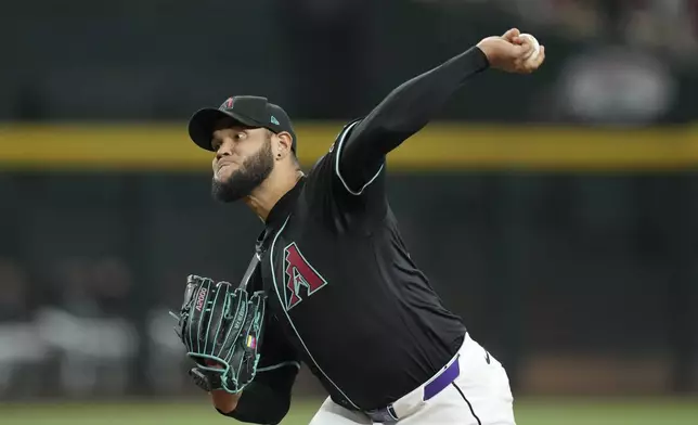 Arizona Diamondbacks starting pitcher Eduardo Rodriguez throws against the Seattle Mariners during the first inning of a baseball game Wednesday, June 11, 2025, in Phoenix. (AP Photo/Ross D. Franklin)