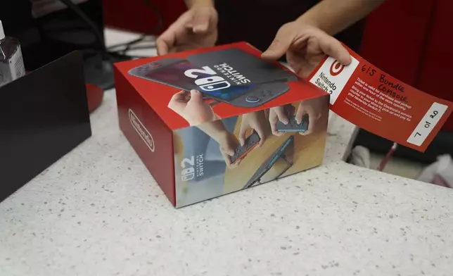 A customer receives the new Nintendo Switch 2 video game console at a Target store on Thursday, June 5, 2025 in Chicago. (AP Photo/Kiichiro Sato)