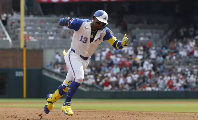 Atlanta Braves' Ronald Acuña Jr. celebrates as he rounds the bases after hitting a home run during the fourth inning of a baseball game against the Boston Red Sox, Saturday, May 31, 2025, in Atlanta. (AP Photo/Butch Dill)