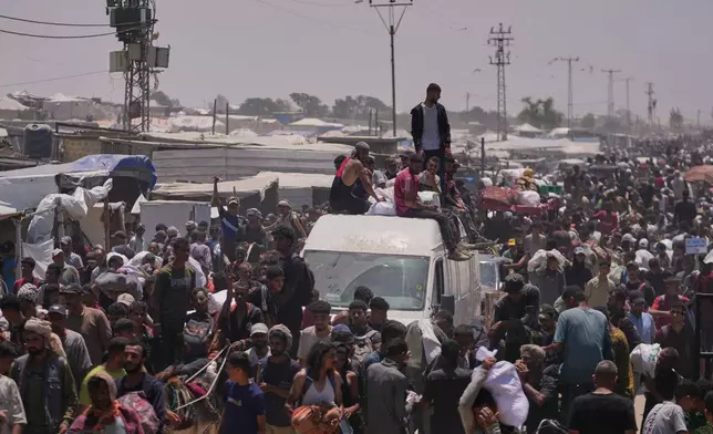 Palestinians carry bags containing food and humanitarian aid packages delivered by the Gaza Humanitarian Foundation, a U.S.-backed organization, in Rafah, southern Gaza Strip, Wednesday, June 11, 2025. (AP Photo/Abdel Kareem Hana)
