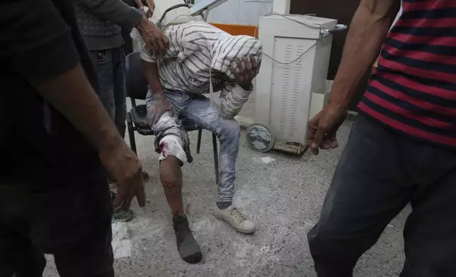 A Palestinian, who was injured last night while trying to get access to humanitarian aid, waits to be treated at the al-Shifa Hospital, in Gaza City, Wednesday, June 11, 2025. (AP Photo/Jehad Alshrafi)