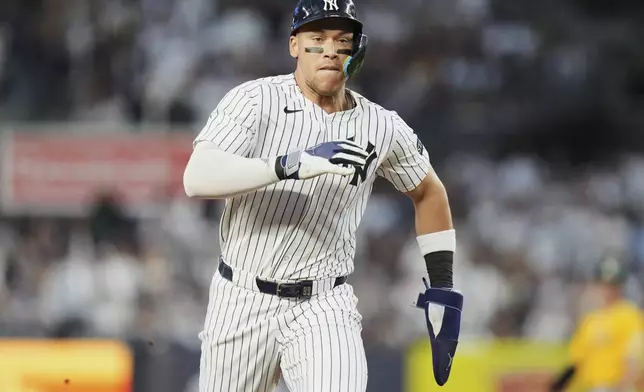 New York Yankees' Aaron Judge runs to third base on an RBI single by Cody Bellinger during the third inning of a baseball game against the Athletics Friday, June 27, 2025, in New York. (AP Photo/Frank Franklin II)