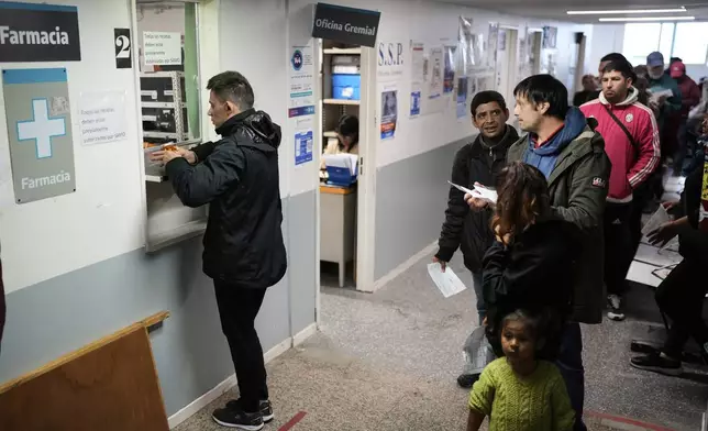 People line up to receive medicine at the Rodolfo Rossi Hospital in La Plata, Argentina, Thursday, May 8, 2025. (AP Photo/Natacha Pisarenko)