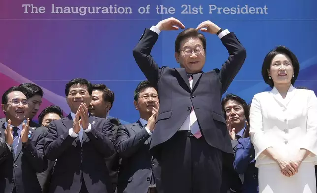 South Korean new President Lee Jae-myung, front left, and his wife Kim Hea Kyung greet to the people after attending the presidential inauguration at the National Assembly in Seoul, South Korea, Wednesday, June 4, 2025. (AP Photo/Lee Jin-man, Pool)