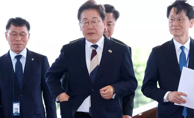 South Korean new President Lee Jae-myung, center, arrives at presidential office in Seoul after the inauguration Wednesday, June 4, 2025. (Chung Sung-Jun/Pool Photo via AP)