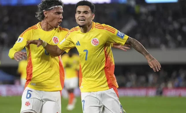 Colombia's Luis Diaz, right, celebrates scoring his side's opening goal against Argentina during a qualifying soccer match for the FIFA World Cup 2026 at the Monumental stadium in Buenos Aires, Argentina, Tuesday, June 10, 2025. (AP Photo/Gustavo Garello)