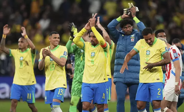 Brazil's players celebrate at the end of a World Cup 2026 qualifying soccer match against Paraguay at Neo Quimica Arena in Sao Paulo, Tuesday, June 10, 2025. Brazil won 1-0. (AP Photo/Andre Penner)