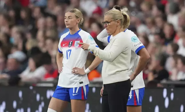 FILE - England coach Sarina Wiegman gestures next to England's Chloe Kelly during the women's Nations League soccer match between England and Portugal at the Wembley Stadium, in London, Friday, May 30, 2025. (AP Photo/Kirsty Wigglesworth, File)