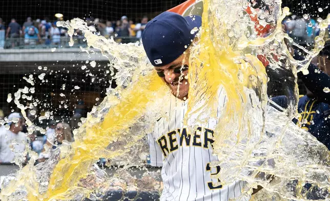 Milwaukee Brewers' Joey Ortiz is doused by teammate Abner Uribe after a baseball game against the Colorado Rockies, Saturday, June 28, 2025, in Milwaukee. (AP Photo/Kayla Wolf)