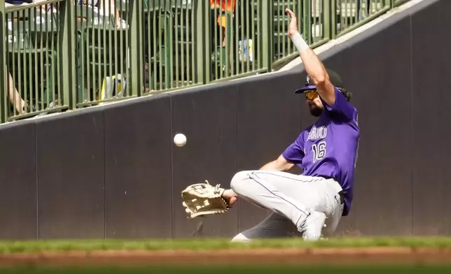 Colorado Rockies outfielder Sam Hilliard misses a ball hit by Milwaukee Brewers' Brice Turang during the third inning of a baseball game Saturday, June 28, 2025, in Milwaukee. (AP Photo/Kayla Wolf)