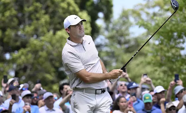 Scottie Scheffler watches his shot from the first tee during the first round of the Travelers Championship golf tournament at TPC River Highlands, Thursday, June 19, 2025, in Cromwell, Conn. (AP Photo/Jessica Hill)