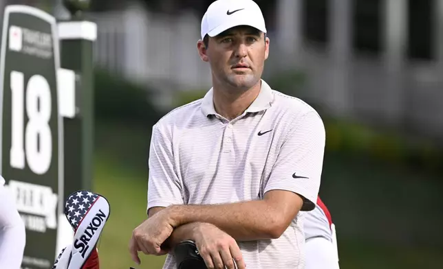 Scottie Scheffler waits at the 18th tee during the first round of the Travelers Championship golf tournament at TPC River Highlands, Thursday, June 19, 2025, in Cromwell, Conn. (AP Photo/Jessica Hill)