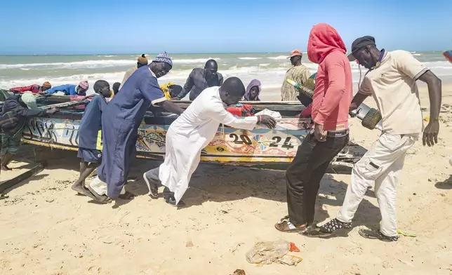Fishermen park their pirogues after returning from fishing in Saint-Louis, Senegal, Thursday, March 13, 2025. (AP Photo/Sylvain Cherkaoui)