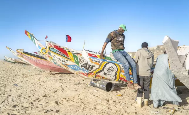 Fishermen park their pirogues after returning from fishing in Saint-Louis, Senegal, Thursday, March 13, 2025. (AP Photo/Sylvain Cherkaoui)