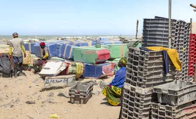 Fishermen prepare to go to sea from the beach of Saint-Louis, Senegal, Thursday, March 13, 2025. (AP Photo/Sylvain Cherkaoui)