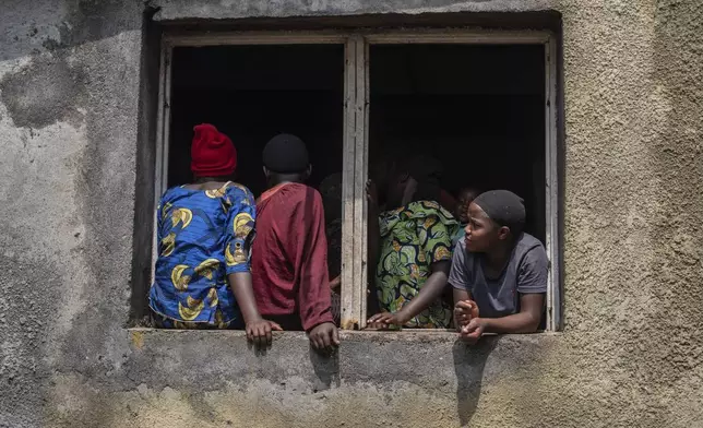 Residents listen to Tom Fletcher, Under-Secretary-General for Humanitarian Affairs and Emergency Relief Coordinator at the Office for the Coordination of Humanitarian Affairs (OCHA), during his visit to North Kivu's town of Buhumba, Democratic republic of the Congo, Thursday, June 26, 2025. (AP Photo/Moses Sawasawa)