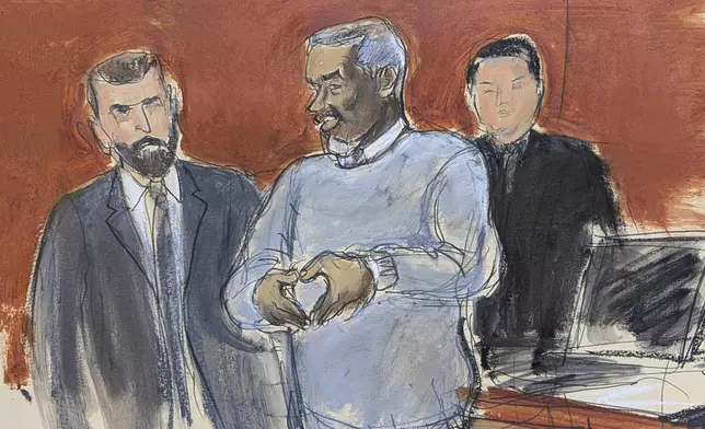 FILE - Sean Diddy Combs, center, motions a heart sign to his family in attendance as he is escorted out of lock-up by U.S. Marshals, on the first day of trial on May 12, 2025, in New York. (Elizabeth Williams via AP, File)