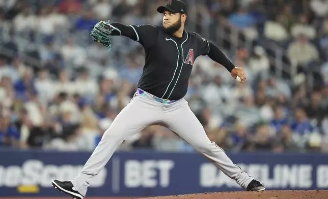 Arizona Diamondbacks pitcher Eduardo Rodriguez (57) works against the Toronto Blue Jays during the first inning of a baseball game in Toronto, Wednesday, June 18, 2025. (Frank Gunn/The Canadian Press via AP)