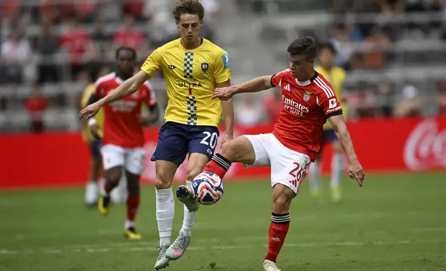 Auckland City's Matt Ellis, left, and Benfica's Samuel Dahl fight for the ball during the Club World Cup Group C soccer match between Benfica and Auckland City in Orlando, Fla., Friday, June 20, 2025. (AP Photo/Phelan Ebenhack)