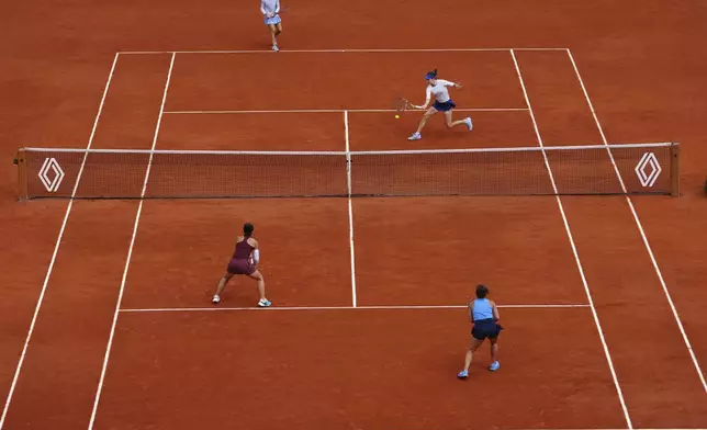 Kazakhstan Anna Danilina, top right, and Serbia's Aleksandra Krunic play a shot against Italy's Jasmine Paolini, bottom right, and Sara Errani during their women's doubles final match of the French Tennis Open at the Roland-Garros stadium in Paris, Sunday, June 8, 2025. (AP Photo/Thibault Camus)