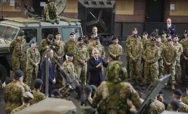 Canada Prime Minister Mark Carney speaks to service personnel after making an announcement as he visits Fort York Armoury in Toronto, Canada, on Monday, June 9, 2025. (Chris Young/The Canadian Press via AP)