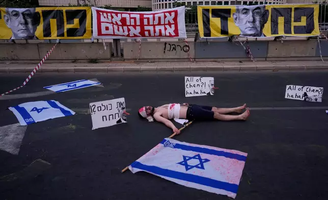 A demonstrator takes part in a performance during a protest demanding the end of the war and immediate release of hostages held by Hamas in the Gaza Strip, and against Prime Minister Benjamin Netanyahu's government in Tel Aviv, Saturday, May 31, 2025. (AP Photo/Ariel Schalit)