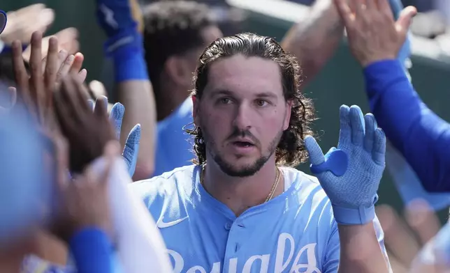 Kansas City Royals' Vinnie Pasquantino celebrates in the dugout after hitting a three-run home run during the fifth inning of a baseball game against the Los Angeles Dodgers, Saturday, June 28, 2025, in Kansas City, Mo. (AP Photo/Charlie Riedel)