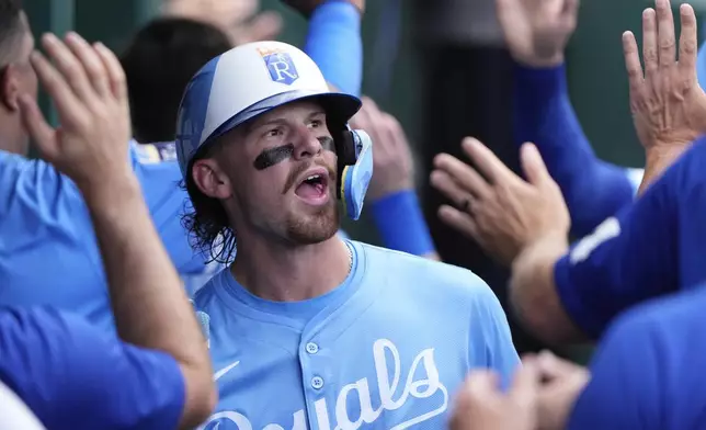 Kansas City Royals' Bobby Witt Jr. celebrates in the dugout after scoring on a double by Maikel Garcia during the third inning of a baseball game against the Los Angeles Dodgers, Saturday, June 28, 2025, in Kansas City, Mo. (AP Photo/Charlie Riedel)