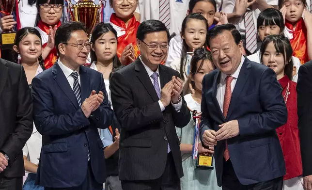 Zhou Ji, director of the Liaison Office of the Central People's Government, from left, John Lee, Hong Kong Chief Executive, and Xia Baolong, director of Hong Kong &amp; Macao Affairs Office, attend the 5th anniversary of Hong Kong National Security Law Forum in Hong Kong, Saturday, June 21, 2025. (AP Photo/Chan Long Hei)